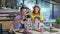 Attractive parents, man and woman, together with their male children, enjoy family dinner at fast food restaurant and