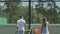 Attractive people give five to each other at the end of tennis game