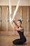Attractive personal trainer will teach your the secrets of aerial yoga