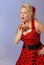 Attractive pinup girl in red polka-dot dress