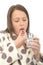 Attractive Poorly Unwell Young Woman Feeling Ill Taking Medicine with a Glass of Water