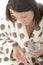 Attractive Poorly Unwell Young Woman Feeling Ill Taking Medicine with a Glass of Water