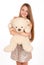 Attractive positive blonde hugging a teddy bear