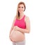 Attractive pregnant woman smiling and holding tummy