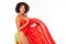 Attractive pretty african girl in a red sexy swimsuit holds a strawberry swimming mattress on a white studio background