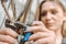 Attractive pretty mechanic refitting the bicycle in the repair shop