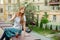 Attractive redhead female sitting on curb in the street