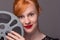 Attractive redhead holding film reel