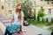 Attractive redhead woman sitting on curb in the street