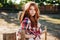 Attractive redhead young woman cowgirl standing outdoors