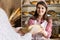 An attractive saleswoman serves the bread bought by a young client. Sale of bread in a traditional bakery store.