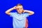 Attractive schoolboy with backpack on the blue background shows a sign V. back to school in second grade