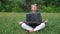 attractive senior business woman, relax in park. Meditation with laptop