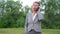 Attractive senior business woman talking on phone, relax in park