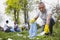 Attractive senior volunteer picking up trash