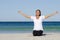 Attractive senior woman stretching at beach