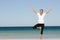 Attractive senior woman stretching at beach