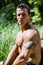 Attractive shirtless young muscleman outdoors in nature