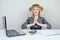 Attractive smart multitasking female person business lady in stylish business suit and a straw hat meditatesin and