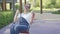 Attractive smiling woman swinging on playground