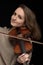 Attractive smiling woman violinist playing violin