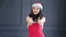 Attractive smiling young Santa Claus woman showing thumbs up cool gesture