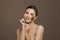 Attractive spa woman with brown scrub on her skin. Facial treatment, body care and skin care concept