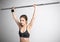 Attractive sports woman lifting barbell