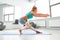 Attractive sportswoman doing exercises on the floor in the modern palates studio Beautiful sportive girl limbering-up