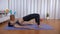Attractive sportswoman doing glute bridge abduction workout on a yoga mat