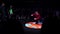 Attractive sporty guy in red clothes dynamically breakdancing on stage