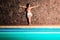 Attractive standing woman on pool edge.