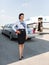 Attractive Stewardess Standing Against Limousine