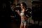 attractive strong adult woman with beautiful athletic body doing exercises with barbell.