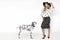 Attractive stylish blonde model in black and white clothes stand near  dalmatian dog. Beautiful fashion model, dressed in pinup