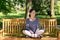 Attractive supple woman sitting on a park bench