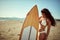 Attractive surf girl posing on the beach