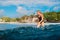 Attractive surf girl on surfboard. Woman in ocean during surfing. Surfer and ocean