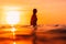 Attractive surfer woman on a surfboard in ocean. Surfgirl at sunset