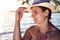 Attractive tanned cute lady wearing hat on beach at sunset on a warm summer evening. dreamy graceful woman on sea beach