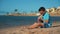 Attractive teen boy in sunglasses drinking lemonade at beach. Boy putting glass
