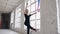 Attractive teenage girl gymnast dancing with colored ribbon in sport gym in white background near windows. Attractive