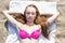 Attractive teenage girl lying on sandy beach