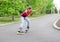 Attractive teenage girl roller skating at speed