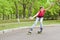 Attractive teenage girl roller skating at speed