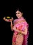 Attractive Thai woman dressed in traditional Thai clothes holds a flower basket