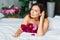 attractive topless woman with a bouquet of peonies on the bed.