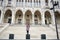 Attractive tourist female stands on background at steps of Parliament