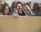 Attractive and upset political activist man protesting in street march screaming holding blank copy space billboard shouting