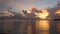 Attractive vibrant sky clouds over ocean at dawn with a floating fishing boat.